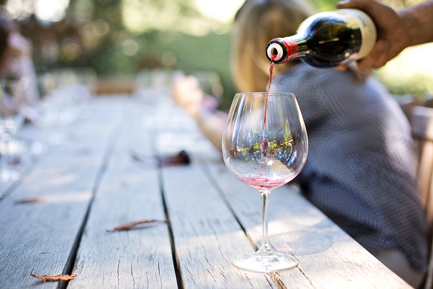 Pouring wine into glass on table