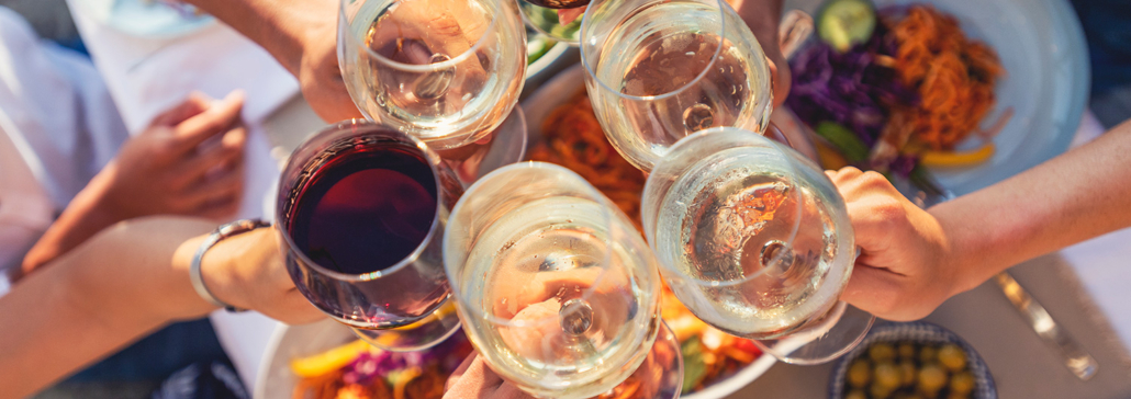 Six people toasting with wine