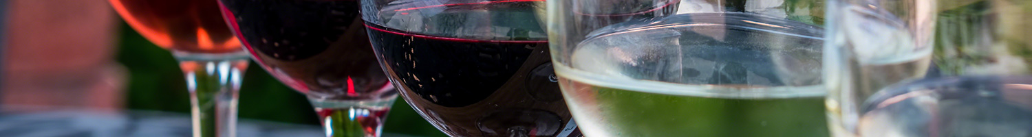 Five wine glasses with different wines